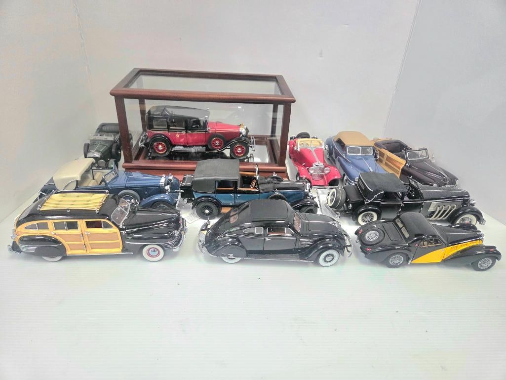 Collection of Franklin Mint Precision Diecast Model Cars: 1935 Mercedes-Benz 770K Grosser touring sedan (red and black), 1:24 scale, displayed in its mahogany-framed glass display case, approx. 9" L model (case approx. 12" L x 6" W x 6" H). Maker's mark:
