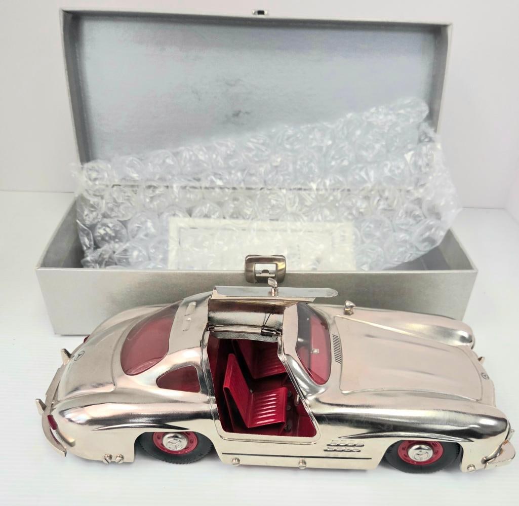 Marklin 1952 Mercedes-Benz 300SL Gullwing Chrome Model Car with Certificate: Polished chrome/silver-finish precision model of the 1952 Mercedes-Benz 300SL Gullwing, red interior, opening gullwing doors, Mercedes three-pointed star grille badge, "1952" dated plate on front bump