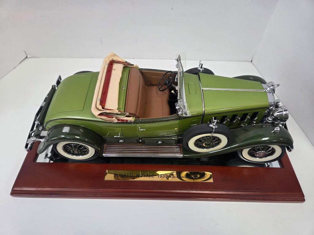 Danbury Mint 1930 Cadillac V-16 Roadster on Wood Display Base: Precision diecast 1930 Cadillac V-16 Roadster, green two-tone body, tan/brown leather-look interior, folded tan convertible top, whitewall wire wheels, rear license plate reading "V16," mounted on a