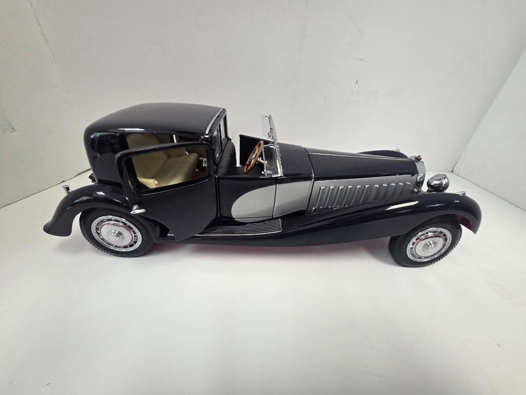 Franklin Mint 1931 Bugatti Royale Coupe de Ville Precision Model: Black and gray precision diecast 1931 Bugatti Royale Coupe de Ville, cream leather-look interior, opening front doors, chrome grille and horn, folding rear windscreen, approx. 14" L x 4" W x 4" H. Mak