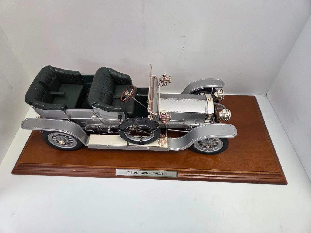 Franklin Mint 1907 Rolls-Royce Silver Ghost on Wood Display Base: Silver precision diecast 1907 Rolls-Royce Silver Ghost open tourer, dark green leather-look seats, brass-tone lamps and fittings, rear registration plate reading "AX 201" (the actual historic Silver G