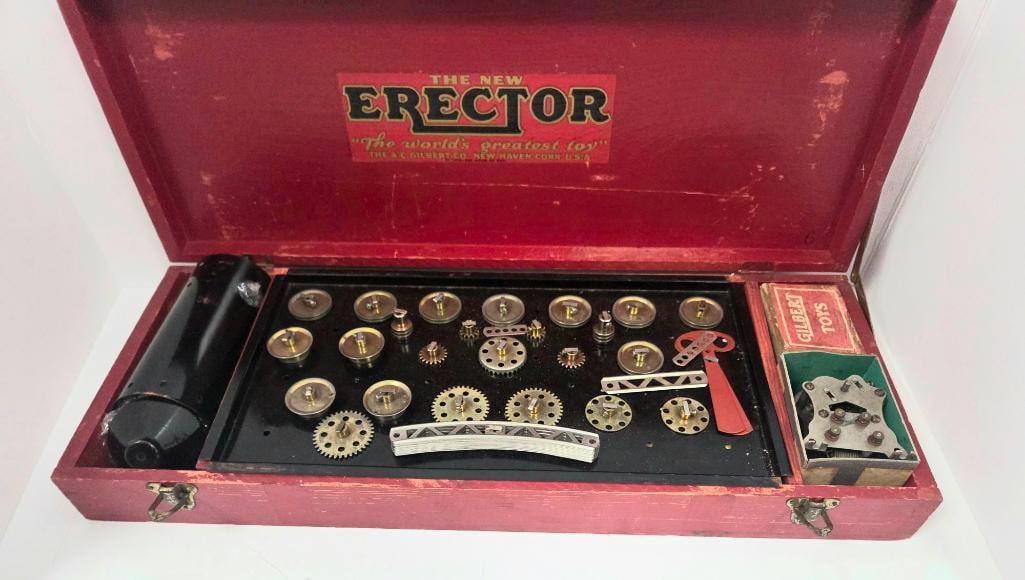 Vintage Gilbert Erector Set in Wooden Box: Vintage "The New Erector, The World's Greatest Toy" construction toy set in a red wooden hinged box, includes electric motor, assorted brass gears, pulleys, girders and connector plates, a small "Gilb