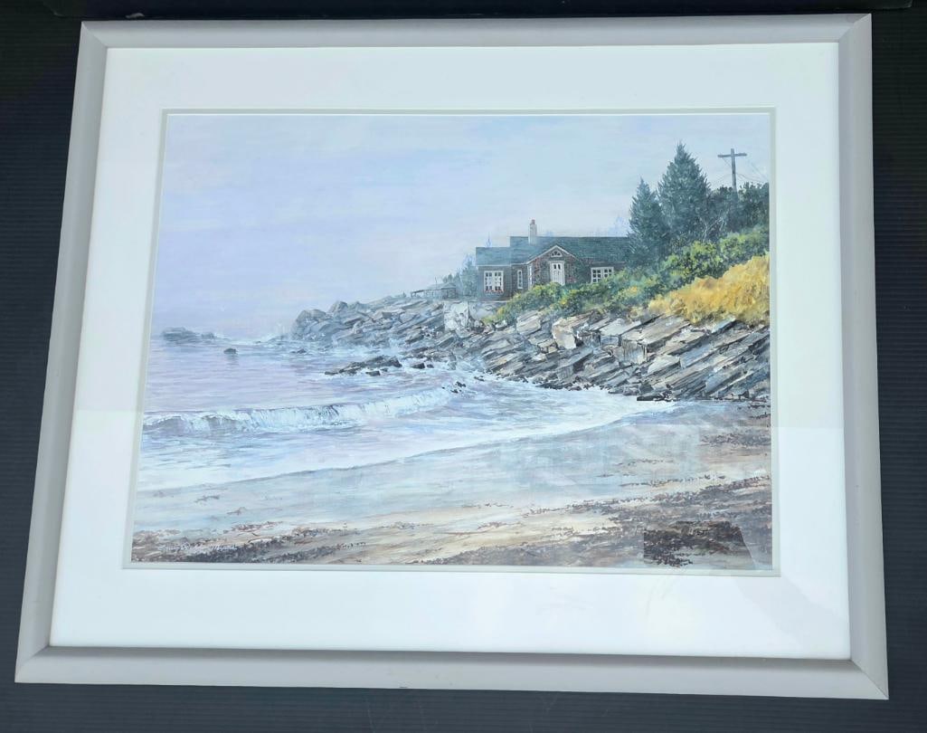 Framed Watercolor of Coastal Cottage and Rocky Shoreline: Framed watercolor/gouache painting depicting a shingled cottage on a rocky New England-style coastline with breaking surf, pine trees, and a utility pole, white mat and gray frame, approx. 24" W x