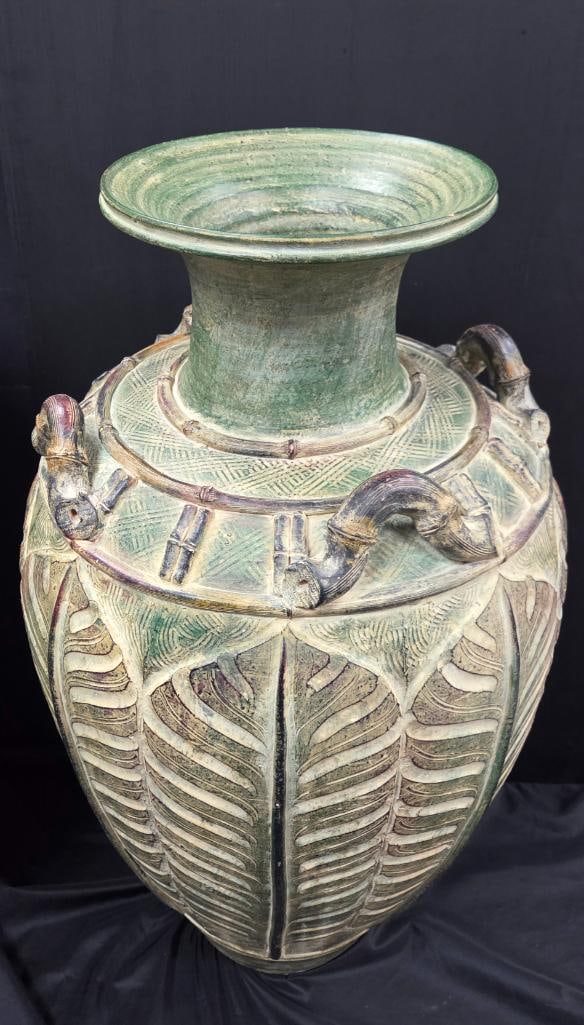 Large Carved Ceramic Floor Urn PAIR with Dragon-Head Handles: Large green-glazed carved ceramic floor urn/vase, flared trumpet neck, four dragon or serpent-head scroll handles around the shoulder, deeply carved vertical leaf/feather motif around the body with