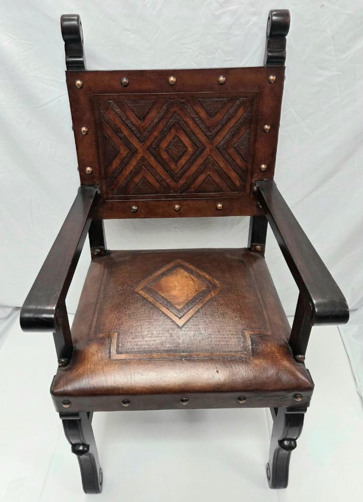Second Matching Spanish/Gothic Revival Armchair with Tooled Leather Back and Seat: Second dark wood armchair, identical design, tooled leather pattern, and dimensions to the chair in Lot 271 (scrolled arm/back terminals, diamond/chevron tooled leather back and seat with brass