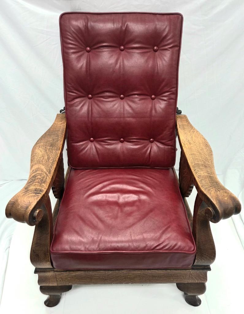 Golden Oak Platform Rocker with Burgundy Leather Cushions: Antique golden oak platform rocking chair, curved paddle arms on carved urn-form supports, cast iron rocking/pivot mechanism, button-tufted burgundy leather back and seat cushions, approx. 36" H x