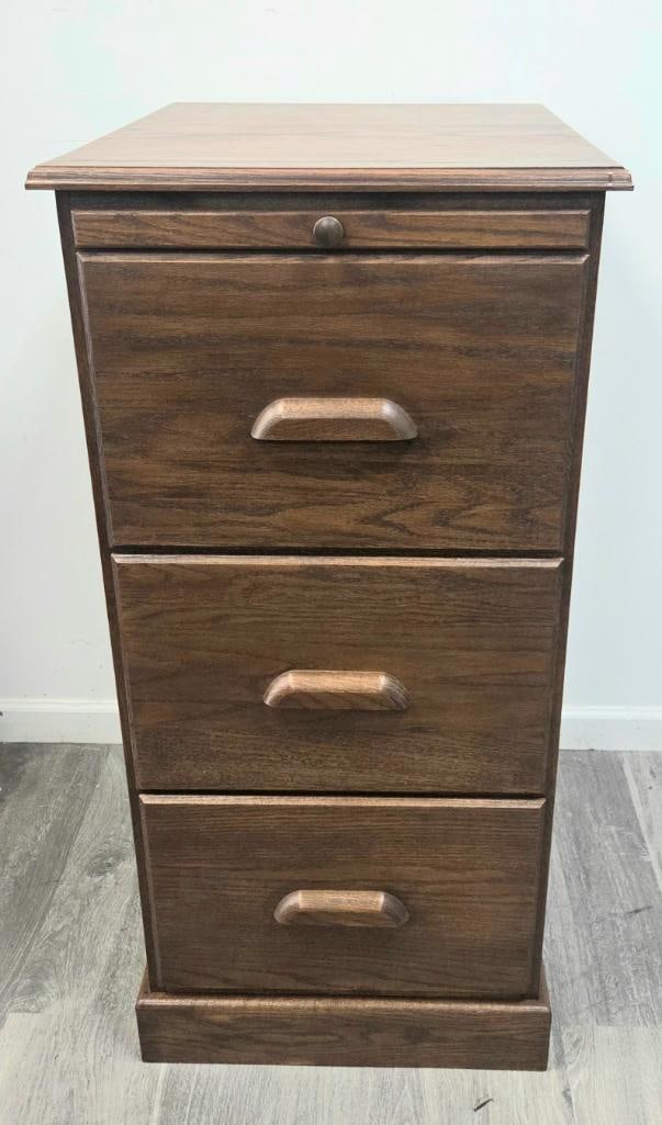 Oak Three-Drawer File Cabinet/Nightstand with Pull-Out Shelf: Oak three-drawer cabinet with a pull-out writing/utility shelf above the drawers, wood knob and bar pulls, plinth base, approx. 28" H x 18" W x 16" D.
