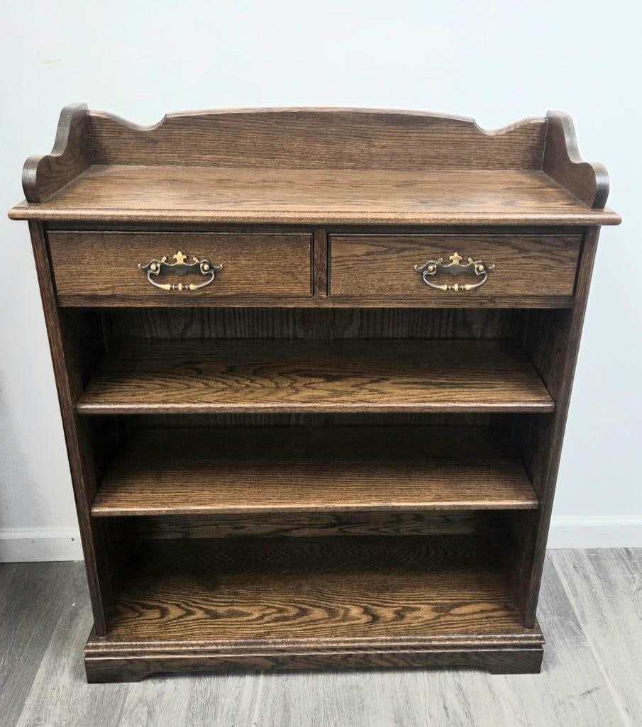 Oak Open Bookcase/Server with Two Drawers and Gallery Rail: Oak open bookcase or server, shaped gallery rail along the back of the top, two drawers with brass drop-bail pulls, two open shelves below, approx. 40" H x 34" W x 14" D.