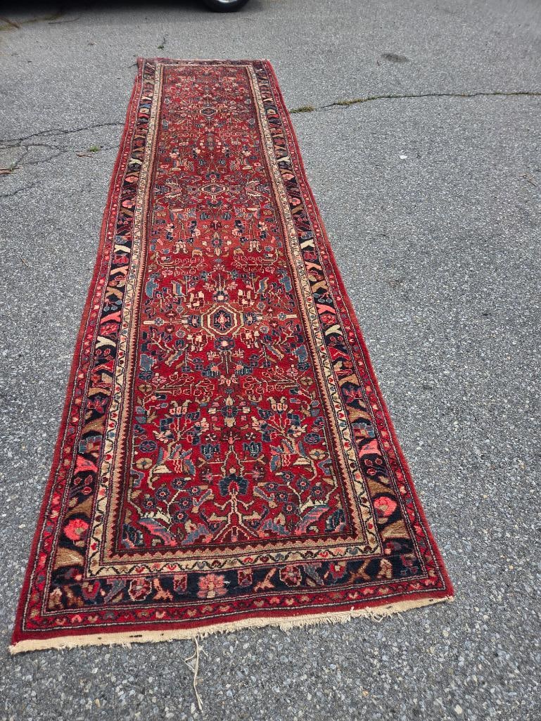Red Persian-Style Wool Runner Rug: Hand-knotted wool runner rug, red field with an all-over floral and geometric medallion pattern in blue, ivory, and rose, multiple guard borders in navy and ivory, fringed ends, approx. 3' W x 10' L.