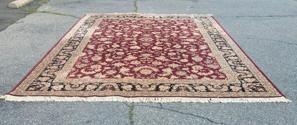 Burgundy Floral Oriental-Style Area Rug: Machine or hand-knotted burgundy/red area rug with an all-over floral vine pattern in ivory and tan, black floral border, fringed ends, approx. 8' x 10'.