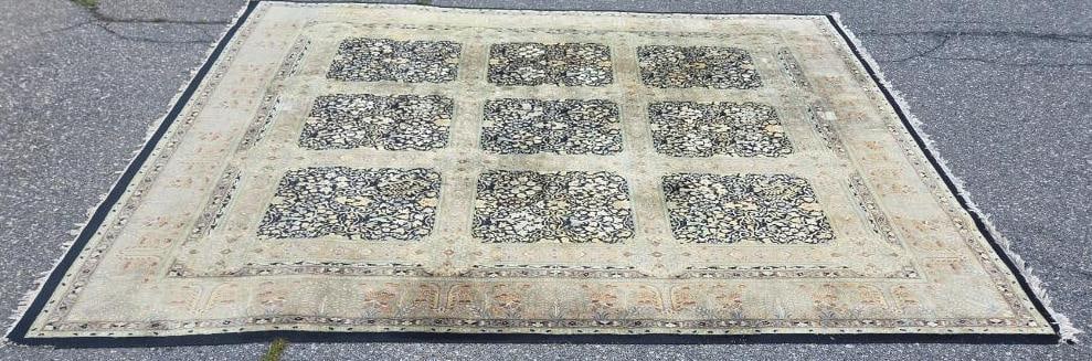 Ivory Nine-Panel Persian-Style Wool Rug: Hand-knotted wool rug, ivory/cream field divided into a nine-panel garden design with dark navy floral panels, pink/tan pictorial guard border, fringed ends, visible wear and fading consistent with ag
