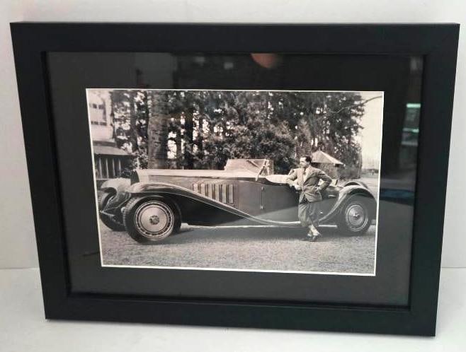 Framed Black and White Photograph of a Man with a Bugatti Royale: Framed black and white reproduction photograph of a man in a suit posed beside a vintage Bugatti Royale touring car, black frame with gray mat, approx. 18" W x 13" H (framed). No maker's mark or photo
