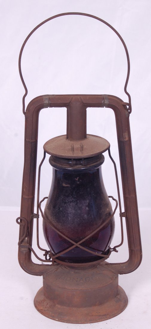 Dietz Monarch Lantern w/ Ruby Red Globe: Dietz Monarch Lantern w/ Ruby Red Globe Dietz Monarch Lantern w/ Ruby Red Globe. Globe measures approximately 6 1/2" tall. Globe unmarked. Lantern has an even coat of rust, but no rust through.