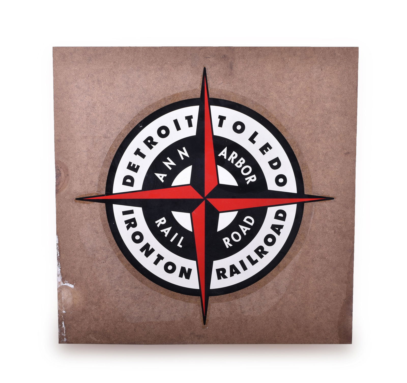 Detroit, Toledo & Ironton / Ann Arbor Railroad Clear: Detroit, Toledo & Ironton / Ann Arbor Railroad Clear backed Decal Mounted to Masonite Board Board measures 18" x 18". Decal is printed on a clear backing and appears unused. Light staining at the edge
