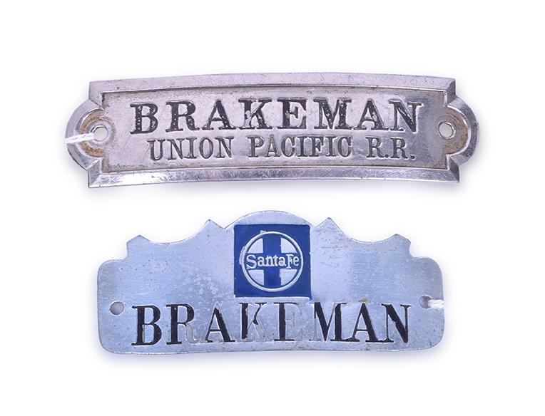 Union Pacific and Santa Fe Nickel Brakeman Cap Badges: Union Pacific and Santa Fe Nickel Brakeman Cap Badges Domed nickel Santa Fe badge with black enamel lettering and blue enamel Santa Fe herald. The badge has some light spotting and loss of the black e