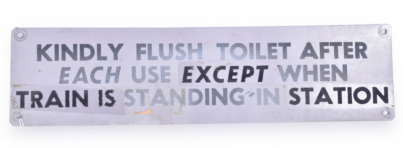 Stainless Steel Railroad Flush Toilet Sign: Stainless steel flush toilet sign. Sign measures 11 1/2" x 3". Sign reads "Kindly Flush Toiler After Each Use Except When Train is Standing in Station" Sign has some overspray and tape residue where s