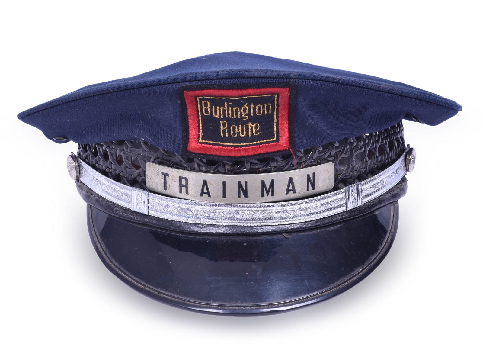 CB&Q / Burlington Trainman Cap: CB&Q / Burlington Trainman Cap Includes both the Trainman badge with strong enamel background. Burlington Route badge is embroidered. Silver banding with CB&Q corner buttons Size is 7 1/8 Kant Krack a