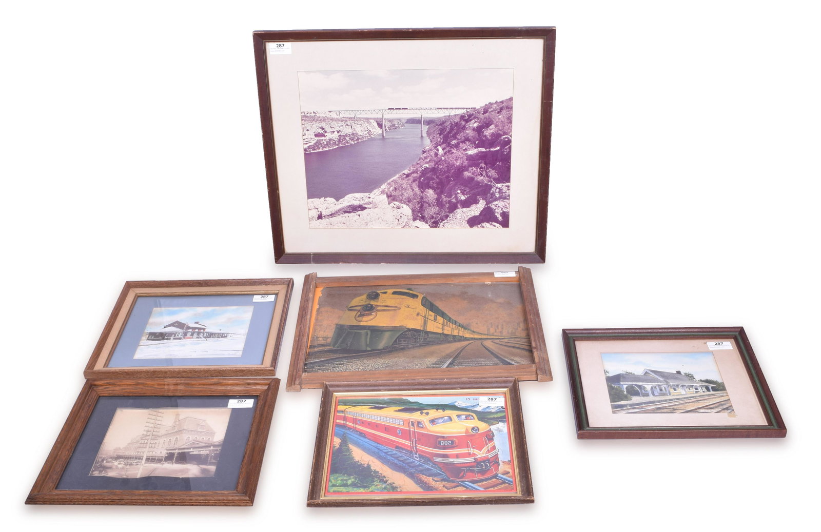Group of Six Railroad Prints, Puzzle, and More: Six railroad related photos, puzzle, and more. Includes Chicago and Northwestern streamlined passenger train print, Milton Bradley 1958 childrens railroad puzzle, 1800's unknown large city station pho