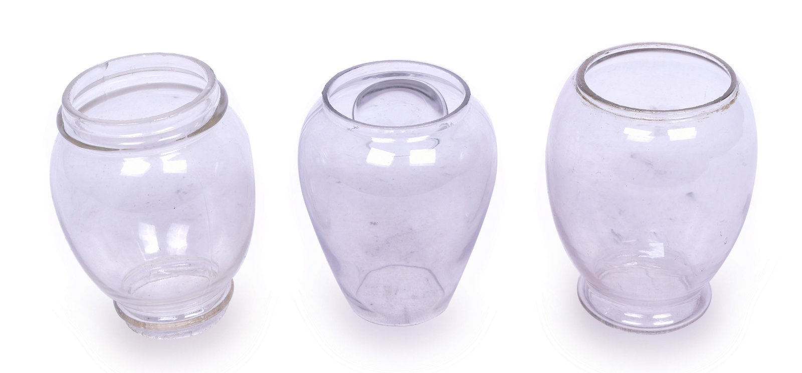 Three Clear Lantern Globes - One Bullseye, Two Rolled Top: Group of three clear lantern globes including 5 5/8" tall globe with Bullseye and a cast patent date of NOV 1 '87. A few tiny nicks in the rims no major chips, cracks or breaks. 6" tall rolled top glo