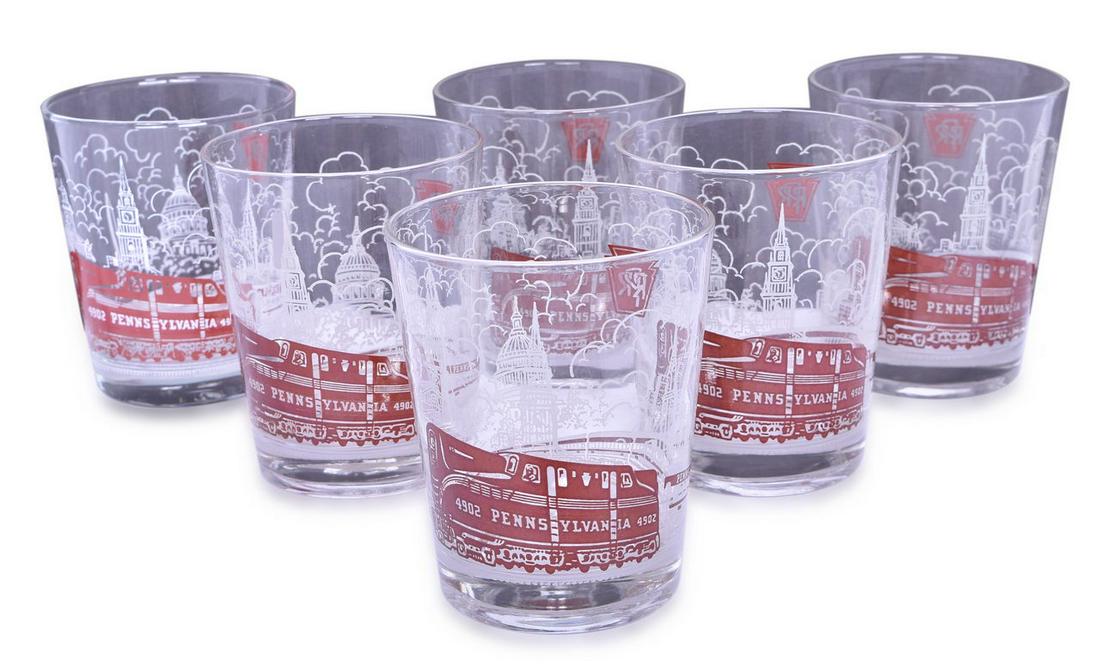 Set of Six Pennsylvania Railroad Drinking Glasses: A set of six drinking glasses with the Pennsylvania Railroad keystone logo and red and white graphics measuring 3 1/2" x 4 1/2" tall. Graphic is of Pennsylvania Railroad Engine #4902. Glasses are in g