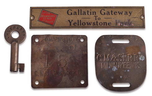 Milwaukee Road Railroad Gallatin Gateway Brass Plate, Switch Key, Tomah Shop Plate, and Luggage Tag: A group of brass items for the Milwaukee Road including a 5" brass plate etched with Gallatin Gateway To Yellowstone Park in black enamel with the Chicago Milwaukee St. Paul And Pacific box logo in re