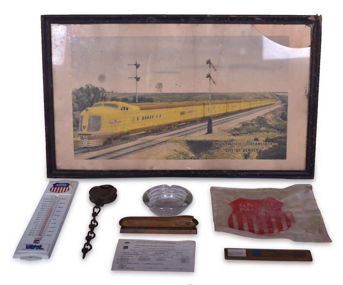 Eight Union Pacific Railroad Items - Glass Ashtray, M-10000 Paperweight, Framed Print, Adlake Brass: A mix of items for the Union Pacific Railroad including a 4 1/4" ribbed glass ashtray with an applied Sun Valley, Idaho Union Pacific Railroad Utah Parks Co. graphic on the bottom. The ashtray shows d