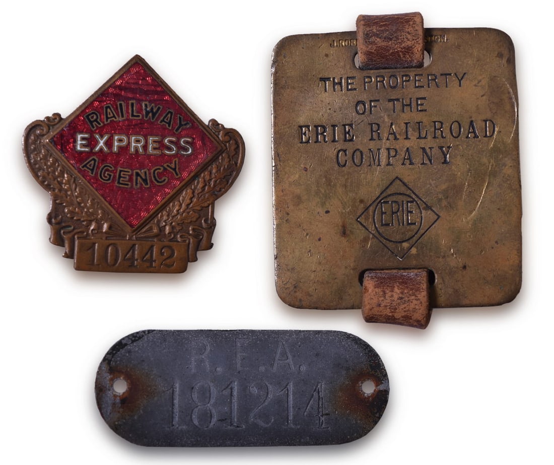 Railway Express Agency Badge, Baggage Cart ID Tag, and Erie Railroad Baggage Tag W/ Diamond Logo and: Three railroad items including a 2" Railway Express Agency 10442 badge of the diamond logo with gold inlay, black, and white enamel lettering, resting on an embossed wreath design, and a burgess clasp