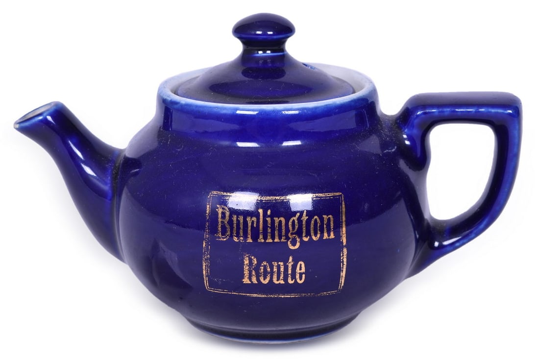 Burlington Route Railroad China Teapot - CB&Q Cobalt Pattern: A Boston style teapot for the CB&Q railroad in the Cobalt pattern, side marked Burlington Route in gold. Measures 4" x 4" x 6 1/4" and shows general signs of use with light scratches and stacking wear