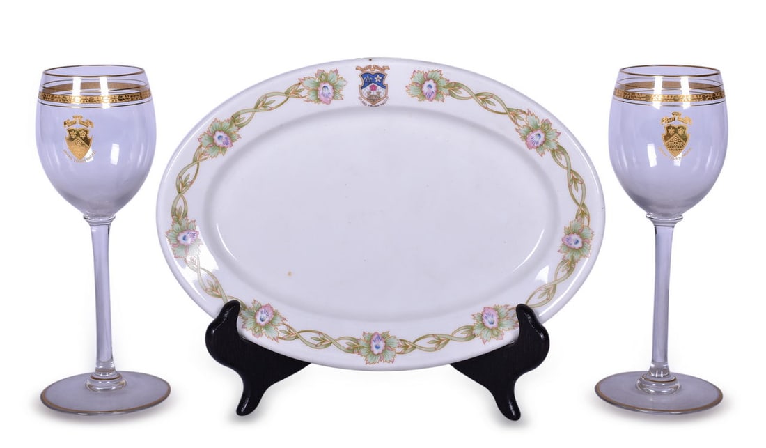 Three Grand Trunk Pacific Railroad Dining Car Items - Stemmed Wine Glasses and Oval China Platter: A group of three dining car items for the Grand Trunk Pacific Railroad. Two 7" stemmed white wine glasses with The Fort Carry Grand Trunk Pacific shield graphic in gold with ornate gold detail around 