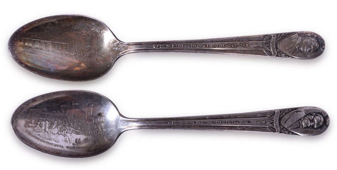 Pair of Silver Railroad Souvenir Spoons - Ulysses S. Grant Transcontinental Railroad 1869 and Grover: A pair of 6" international silver railroad souvenir spoons. A spoon marked on the handle with a portrait of Ulysses S. Grant and an embossed Transcontinental Railroad 1869 graphic in the bowl. The han