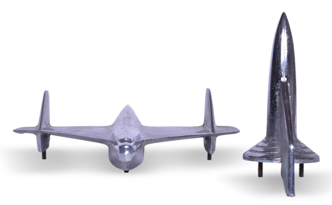 Pair of Chevrolet Rocket Style Hood Ornaments - 1955 Full Size and 1957 Bel Air & Nomad Rocket: A pair of Chevrolet hood ornaments including a full size 1955 ornament in the jet bird plane style, cast by BLC with part number 3709685, measuring 14 7/8" long x 9 1/8" wide. Shows some pitting and c
