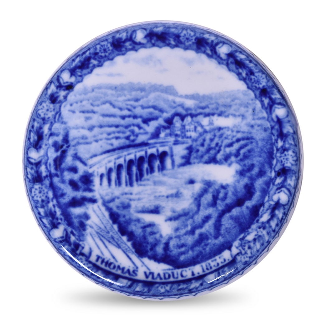 Baltimore and Ohio Railroad China Centenary Cover Lid: A 4" china cover lid for the Baltimore & Ohio Railroad in the Centenary pattern with the Thomas Viaduct graphic, unmarked. The piece is in great condition showing only a few light tiny scratches. No c