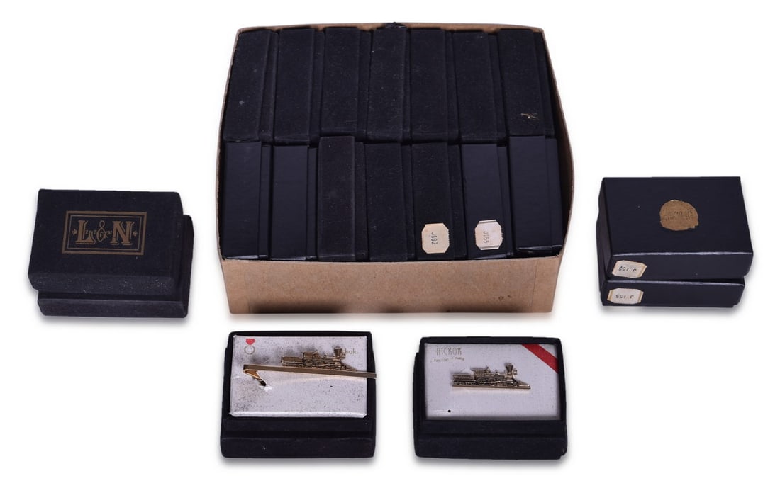 Twenty Louisville and Nashville Railroad The General Tie Bar - New Old Stock Hickok: A collection of twenty new old stock The General steam locomotive tie bar clips in original packaging. The brass plated tie bars measure 1 5/8" and show minimal to no signs of use but the boxes show g