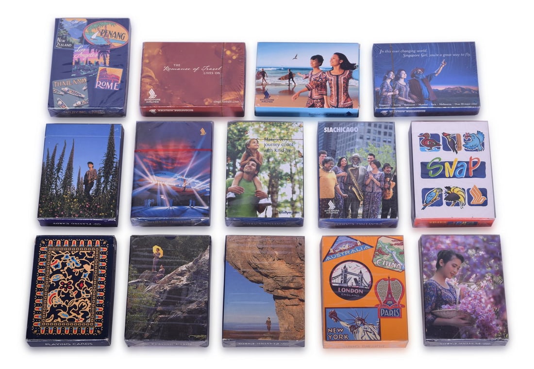 Fourteen Singapore Airlines Playing Card Decks Including New Old Stock: A collection of souvenir playing cards advertising Singapore Airlines, all in sealed or opened but unused condition. All with different designs. Includes five decks with Singapore Girl and landscape, 