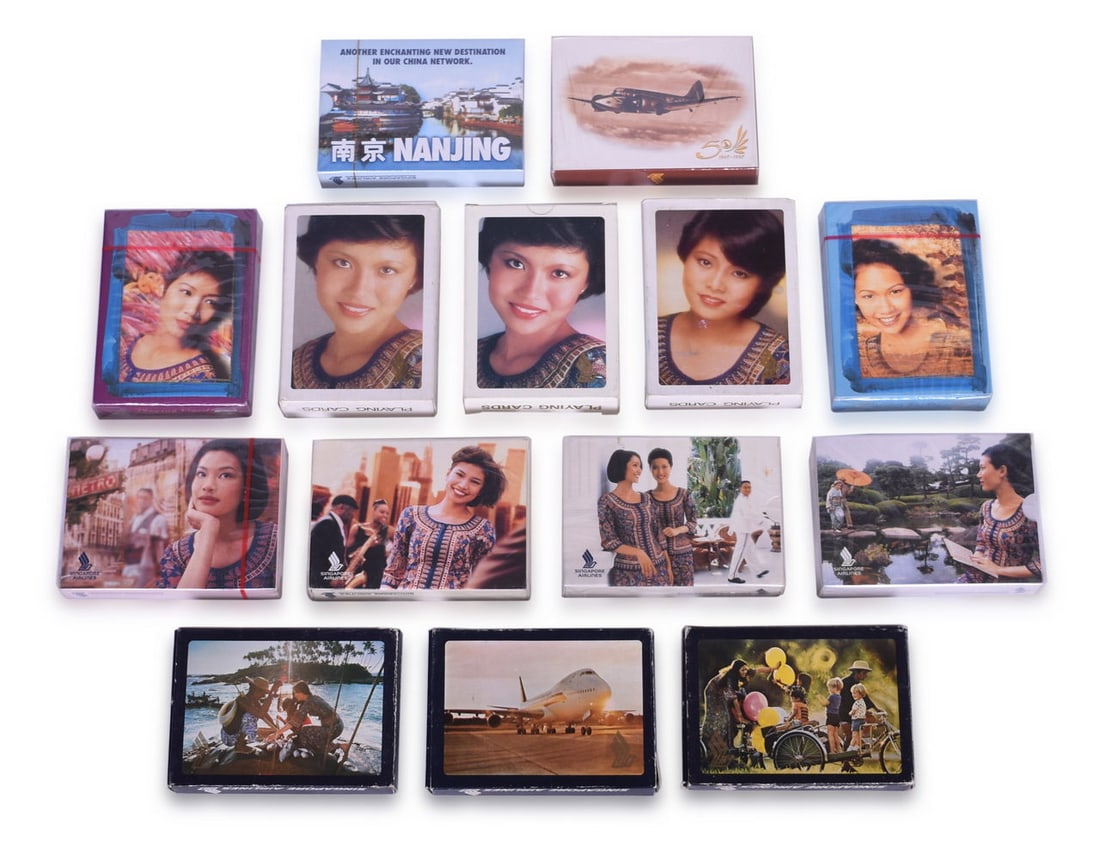 Fourteen Singapore Airlines Playing Card Decks Including New Old Stock: A collection of souvenir playing cards advertising Singapore Airlines. Ten are sealed and the others are opened but in unused condition. All with different designs. Includes six decks with Singapore G