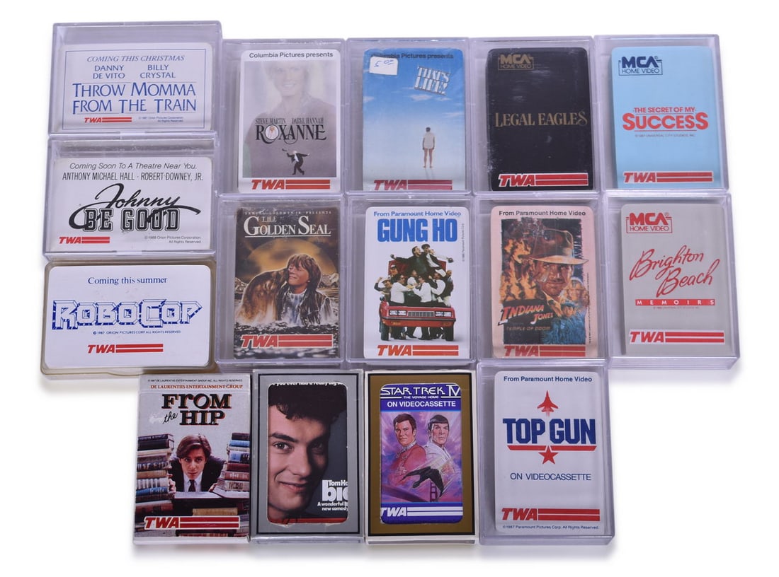 Fifteen TWA Airlines Playing Card Decks Advertising Hollywood Movies - Top Gun, Star Trek IV,: Group of Trans World Airlines playing card decks advertising Hollywood movies from the 1980s, all showing minimal to no signs of use. Designs include Top Gun, Star Trek IV, Indiana Jones, Big, RoboCop