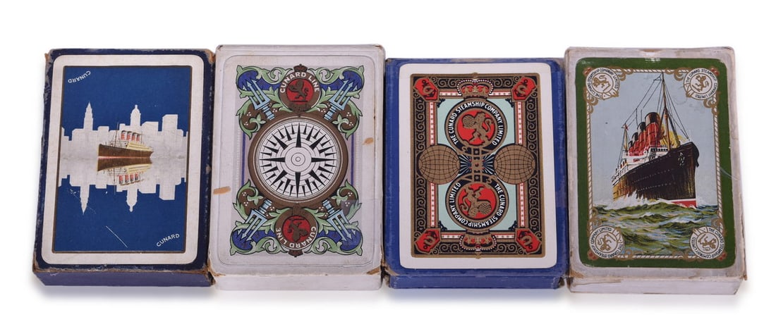 Four Cunard Line Steamship Playing Card Decks: Playing card decks for Cunard Line from the 1920s and 1940s all in original cardboard sleeves. Includes a 1920 deck with large ship graphic, green border, and logo at each corner. The deck has 52 play