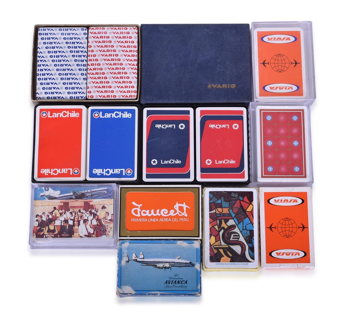 Thirteen Vintage South American Airline Playing Card Decks - Varig, LanChile, Avianca, Faucett Per: Collection of playing card decks advertising airlines in South America. Decks for the Brazilian airline Varig include a sealed double deck in flocked box, red design deck, and cabin illustration deck,