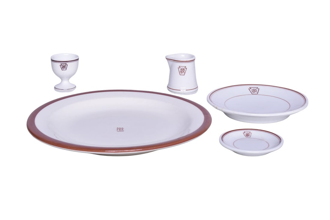 Five Pieces of Pennsylvania Railroad Keystone China Egg Cup, Creamer, Butter Pat, and Gotham Service: Five Pieces of Pennsylvania Railroad Keystone China Egg Cup, Creamer, Butter Pat, and Gotham Service Plate Includes a single pedestal egg cup by Ohio Pottery Co. Albert Pick, measuring 2 1/4" tall, sh