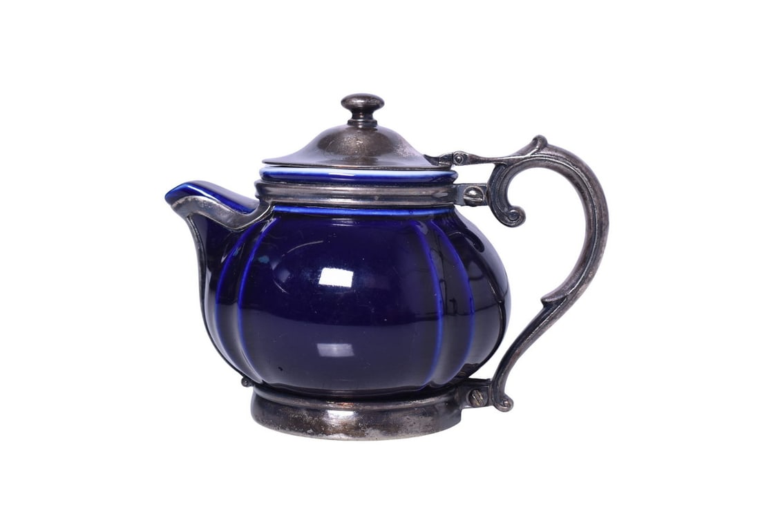 Reed & Barton Southern Pacific Lines Railroad Cobalt Blue China Teapot w/ Silver Frame: A cobalt blue china tea pot with silver soldered frame by Reed and Barton, top marked on the lid with the Southern Pacific Lines Sunset logo and bottom stamped under the lid Reed & Barton 5329-S. Meas