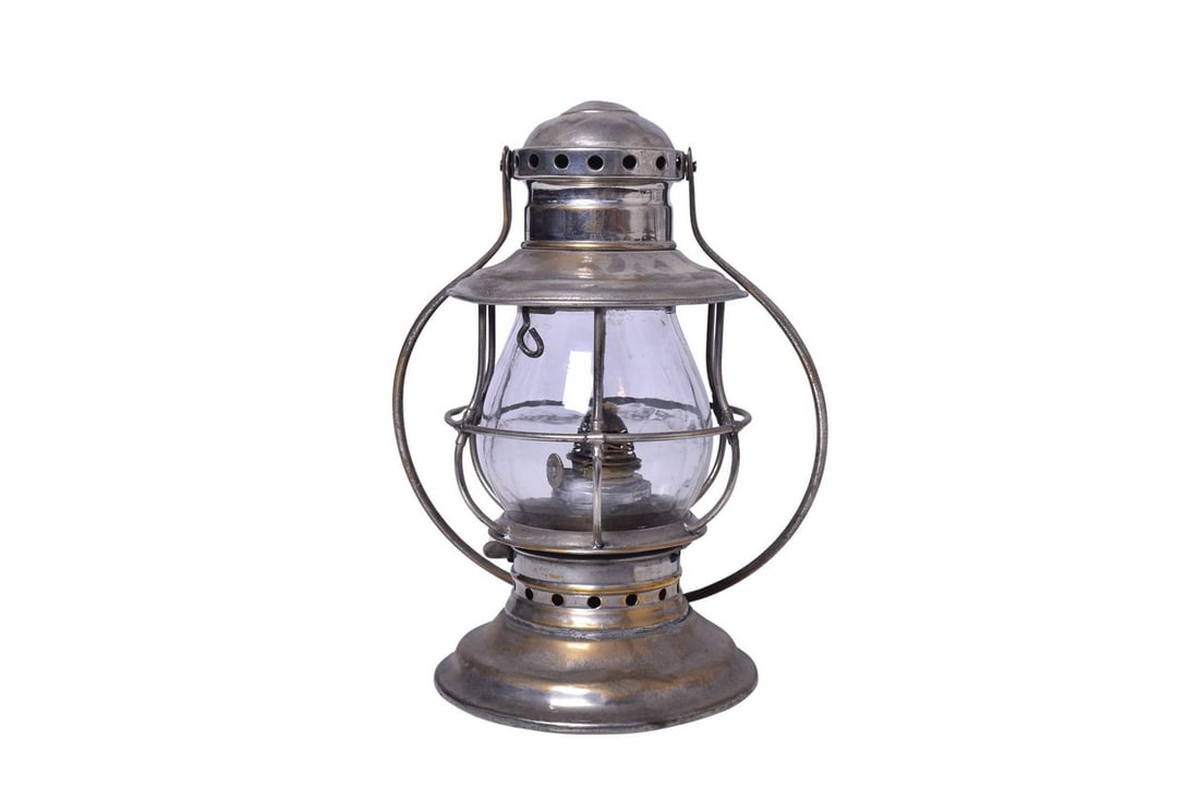 Nickel Plated Bell Bottom Presentation Railroad Lantern: An early 1900s nickel plated bell bottom presentation lantern, unmarked. Measures roughly 9 3/4" tall. The body shows moderate signs of wear with discoloration, spots of plating wear, and minor dents