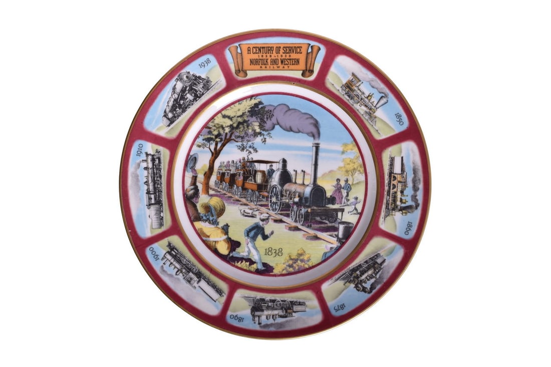 Norfolk & Western Railroad China 1938 Centennial Service Plate: A 10 1/2" service plate for Norfolk and Western Railroad Centennial in 1938 depicting the history of the line with eight scenes of locomotive development from the small wood burning locomotive to the