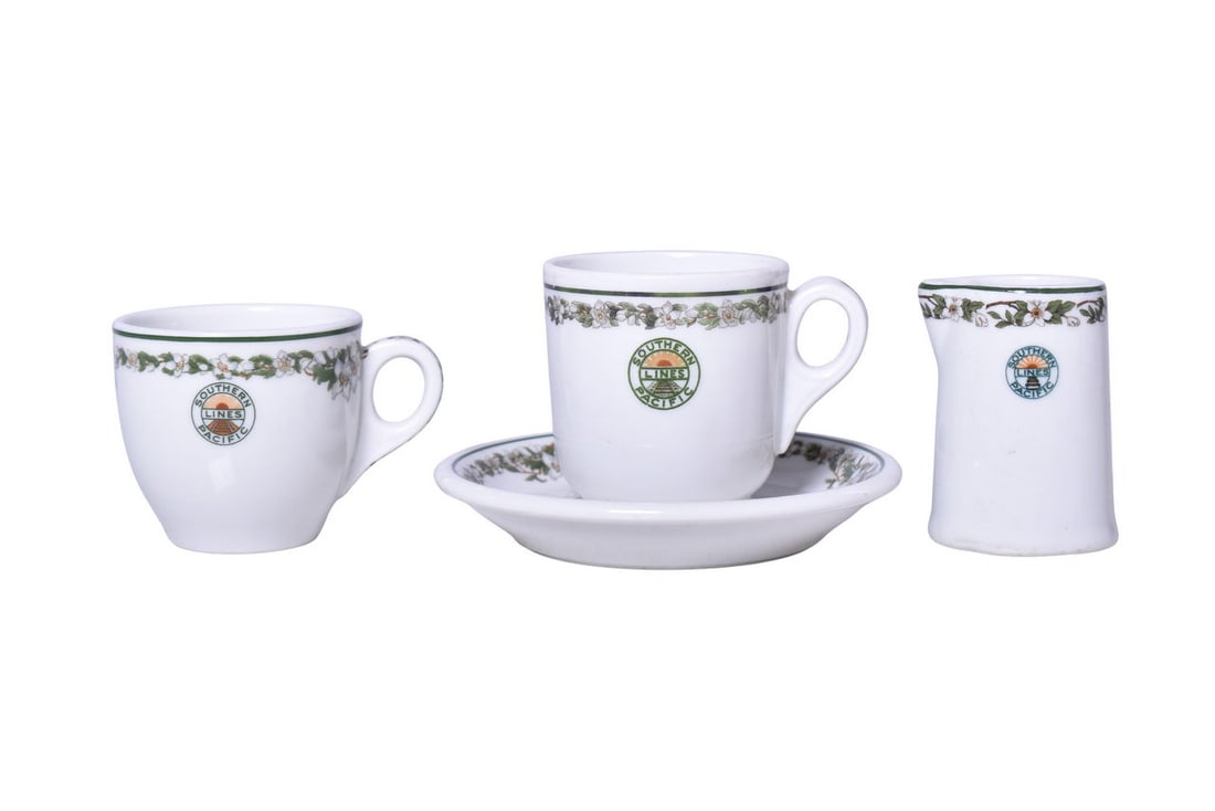 Southern Pacific Lines Railroad China Sunset Creamer, Demitasse Cup, and Saucer: Four pieces of dining car items for the Southern Pacific Railroad marked with the Sunset logo, including three pieces in the Large Flowers pattern. Large Flowers pieces include a 2 1/2" tall cup