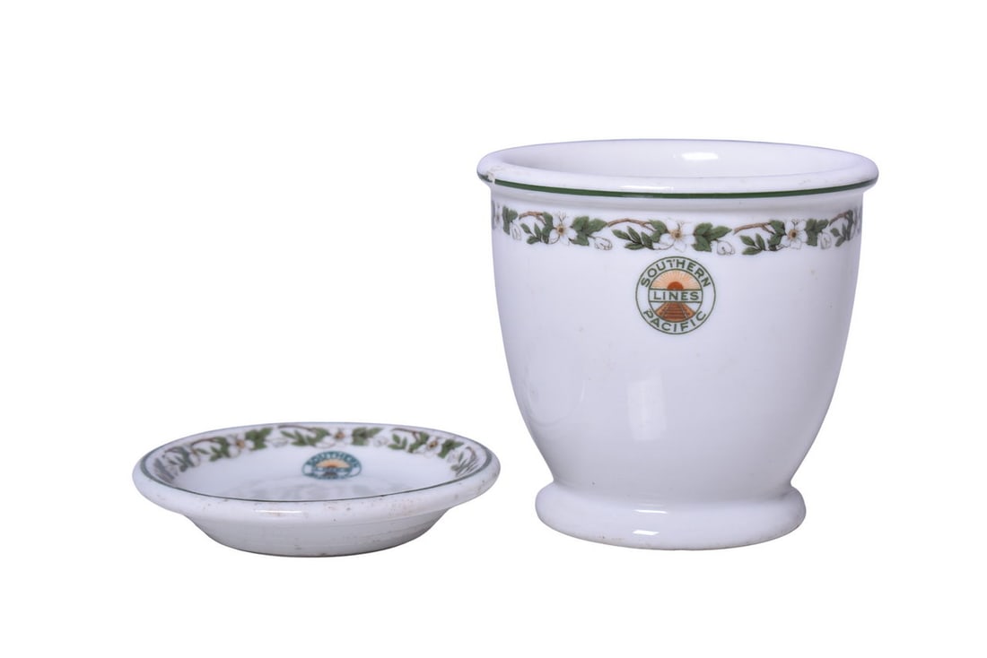 Southern Pacific Railroad China Sunset Butter Pat and Double Egg Cup: Pair of dining car items for Southern Pacific Lines in the Sunset pattern. Includes a 3" butter pat, no makers mark, showing no use but discoloration ink specks in the middle, along the edge, and acro