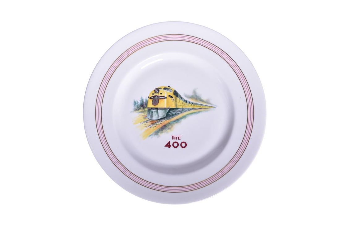 Chicago & North Western Railroad China The Famous "400" Flambeau Service Plate: A 10 1/2" china service plate in the Flambeau pattern for Chicago and North Western Railroad, top marked with The 400 and multicolor locomotive graphic with metallic silver detail on the front end. Th