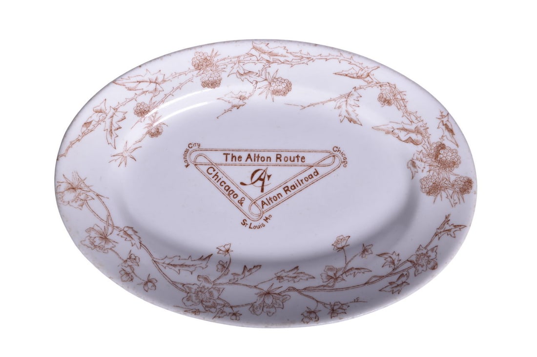 Chicago & Alton Railroad Greenwood China Oval Platter Plate: A 10 7/8" by 7 1/2" oval platter for the Chicago & Alton Railroad in the Alton pattern, top marked with the Alton Route logo and bottom stamped Greenwood China Trenton NJ in the ware. The platter show