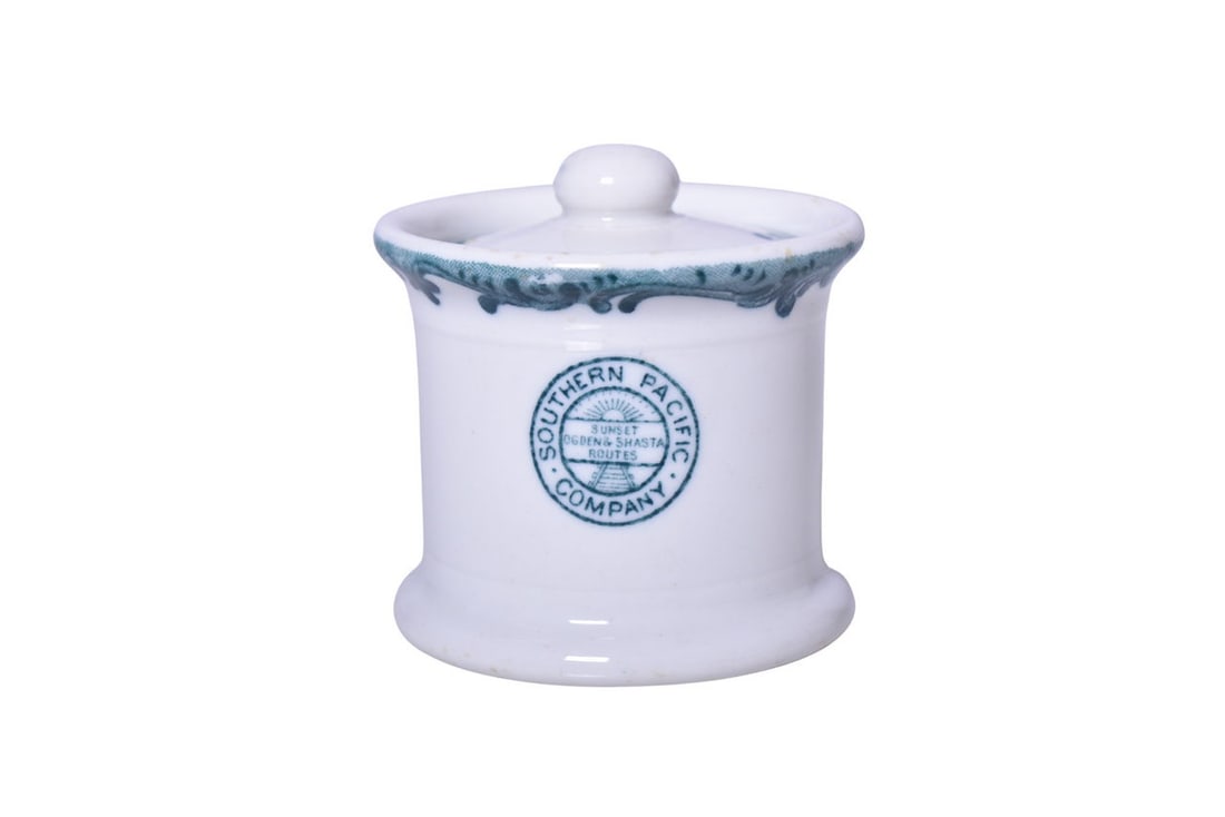 Southern Pacific Railroad China Harriman Blue Mustard Pot w/ Lid: A 3" tall by 3" diameter mustard pot with notched lid for the Southern Pacific Railroad in the Harriman Blue Top Logo pattern, side marked with the Sunset Ogden & Shasta Routes logo, by Maddocks. Show