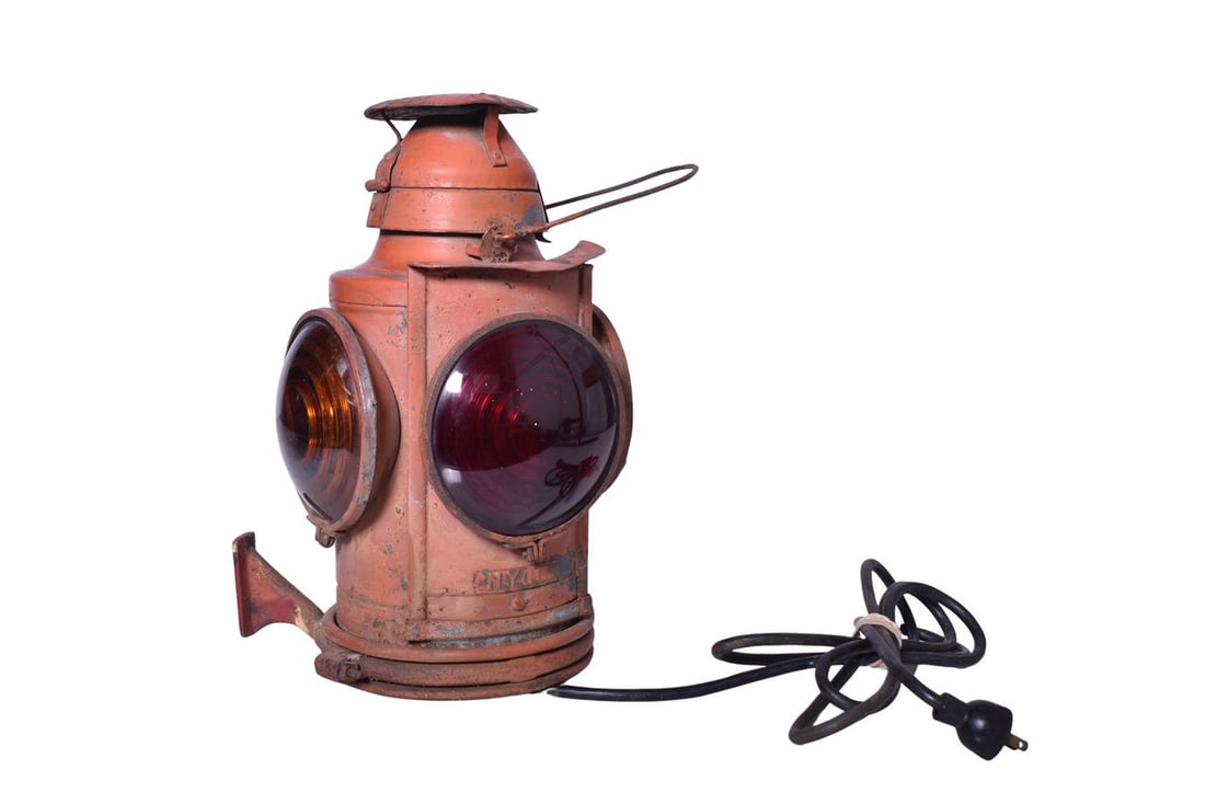 Handlan New York Central Railroad Marker Lamp: Handlan round top marker lamp with embossed tag on the door which reads NYCS. Equipped with three amber and one red lens. The metal pull lip has partially bent / separated from the door and the lamp h