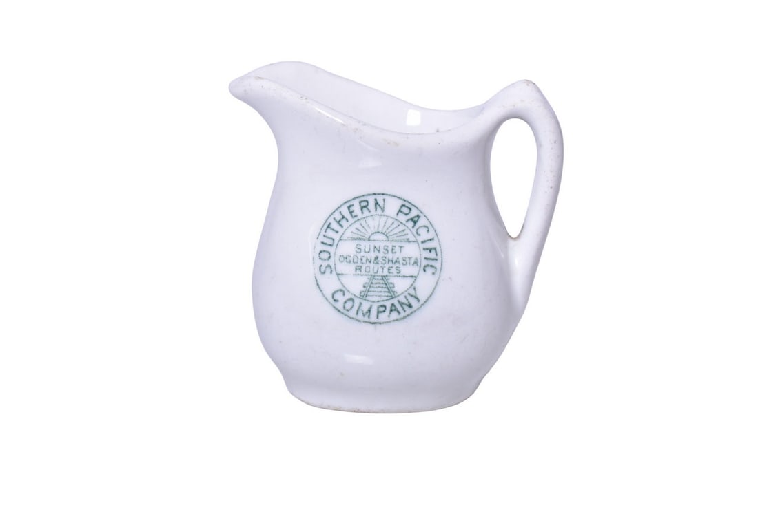 Southern Pacific Railroad China Stanford Green Creamer: A 2 3/4" tall cream pitcher for the Southern Pacific Company Railroad in the Stanford pattern, side marked with the Sunset Ogden & Shasta Routes logo, by John Maddock & Sons. Shows some light scratche