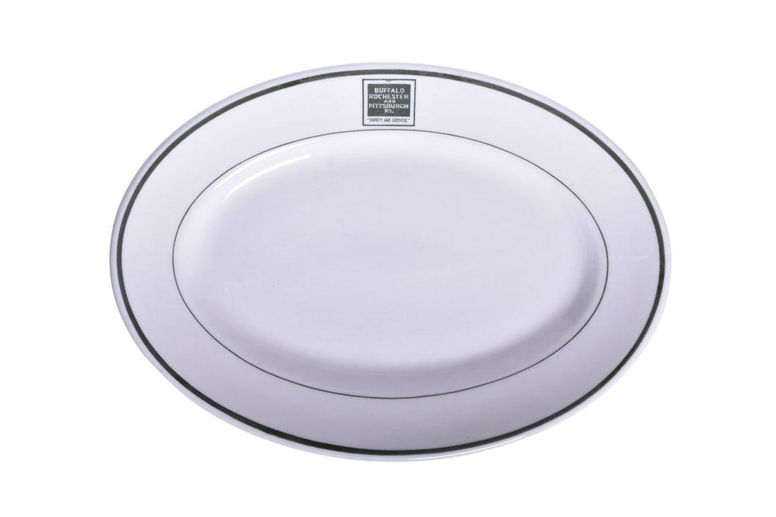 Buffalo Rochester and Pittsburgh Railway China Safety Slogan Oval Platter Plate: A 10 1/2" china oval platter plate for the Buffalo Rochester and Pittsburgh Railroad in the Safety Slogan green pattern, top marked with the "Safety and Service" box logo and bottom marked Mayer Made